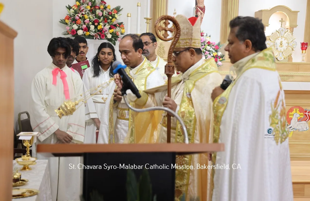 Bishop with mitre and crosier surrounded by concelebrating priests and altar servers at the sanctuary