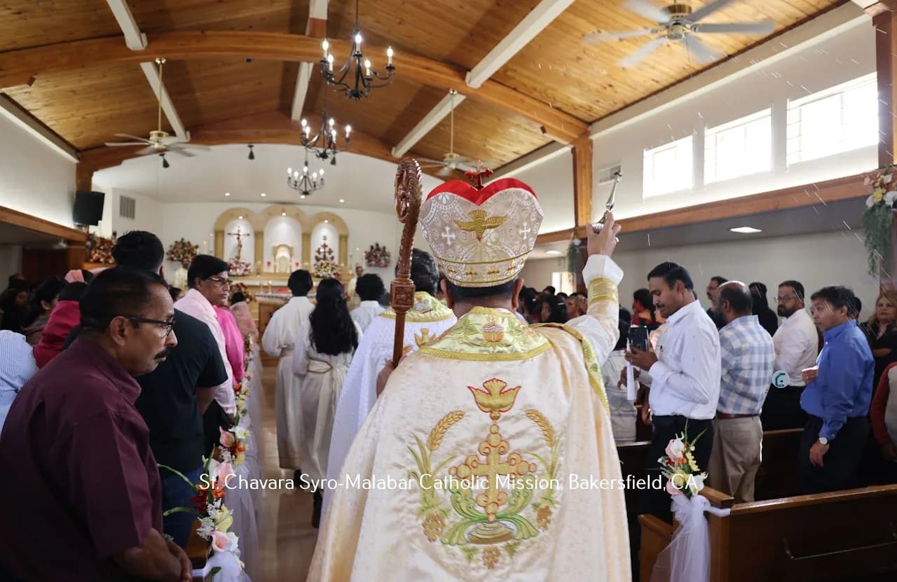 Bishop sprinkling holy water over the congregation while processing up the church aisle