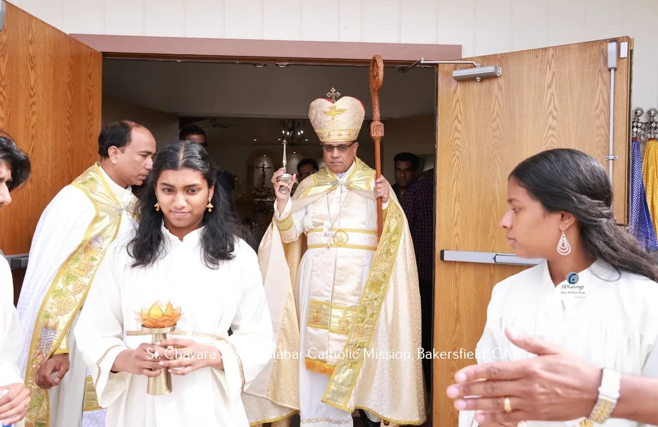 Bishop swinging a censer and holding his crozier as he processes out through the church doors